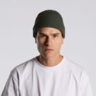 Man in a white t-shirt and green beanie hat facing forward against a plain background.