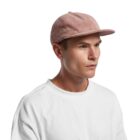 Man in a white shirt wearing a pink corduroy cap, looking to the right.