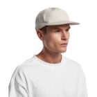 Man wearing a white T-shirt and beige baseball cap, facing right on a white background.