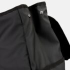 Close-up of a black fabric bag with button details.