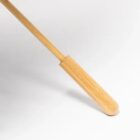 Long wooden shoehorn on a white background.