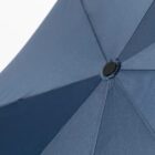 Close-up view of a dark blue umbrella from below, showing its center and fabric seams.