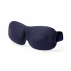 A navy blue contoured sleep mask with an adjustable strap.
