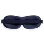 Black sleep mask with an adjustable elastic band, shown from the back.
