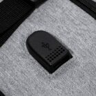Close-up of a black USB port on a gray fabric surface.