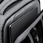 Laptop inside an open, gray backpack pocket.