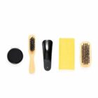 Shoe care kit with two brushes, shoe polish, cloth, and shoehorn.