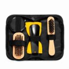 Shoe shine kit with brushes, cloth, and polish in a black case.