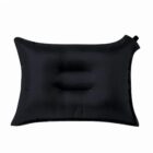 Black inflatable travel pillow with a valve on a white background.