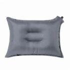 Gray inflatable travel pillow with a built-in valve.
