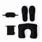 Black travel set with slippers, eye mask, neck pillow, and pouch on a white background.