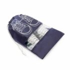 A shoe bag with a drawstring, holding a pair of white sneakers.