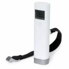 White digital luggage scale with a black strap attached.