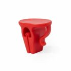 Red plastic bag carrier tool with a handle and a smooth surface.