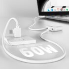 Laptop charging with a white cable, displaying Fast charge up to 60W on the surface.