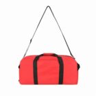 A red duffel bag with black handles and a black adjustable shoulder strap.