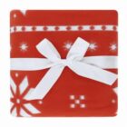 Red blanket with white snowflakes, wrapped with a white ribbon tied in a bow.