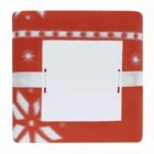 Red and white blanket with snowflake patterns and a blank white label in the center.