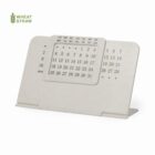 A minimalist desk calendar made from white wheat straw material.