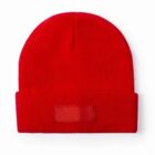 A plain red knit beanie with a folded brim, photographed on a white background.