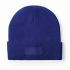 Royal blue knit beanie hat with a folded brim on a white background.