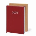 Red 2025 planner standing in front of a brown notebook against a white background.
