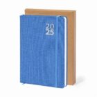 Blue 2025 planner with elastic band, standing in front of a plain brown box.