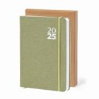 Green 2025 planner notebook with elastic band, standing in front of a brown box.