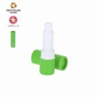 Green vanilla lip balm stick with cap off, made from recycled paper.