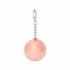 A silver chain earring with a dangling round peach-colored bead.
