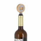 A wine bottle with a wooden bottle opener as its stopper on top.