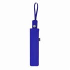 A closed blue umbrella in a matching sleeve with a loop handle.