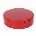 Red metal jar lid with vertical ridges, shown against a plain white background.