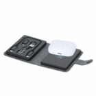 A portable charging kit with cables and a wireless charging pad in a gray fabric case.