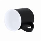 A black coffee mug lying on its side with a white interior on a white background.