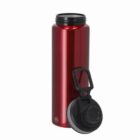 Red stainless steel water bottle with a black screw-on lid placed beside it.