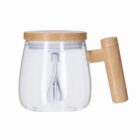 Clear glass teapot with a wooden lid and handle, and an infuser inside.