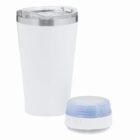 White tumbler with clear lid next to a small round white and blue wireless speaker.