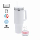 White travel tumbler with handle, clear lid, straw, and small round speaker beside it.