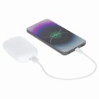 A smartphone charging with a white power bank using a USB cable.