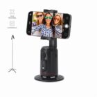 A smartphone on a rotating tripod stand takes a selfie of three smiling women.