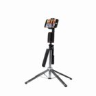 A smartphone on a tripod, displaying a selfie of three people.