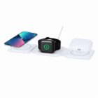 White triple wireless charger charging a smartphone, smartwatch, and earbuds case.