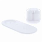 Minimalist white wireless charging pad and a cylindrical device with a clear top cover.