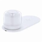A white wireless charging pad with a round, dome-shaped charging compartment.