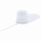 White wireless charging pad with a dome-shaped device and attached charging cable.