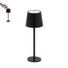 A black table lamp with a touch control on top; a hand is shown touching the lamp.