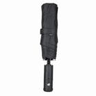 A closed black compact umbrella with a button on the handle.