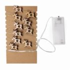 String lights with wooden reindeer clips and a battery pack on a cardboard backing.