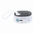 Small portable speaker with a fabric top, white base, and a looped carrying strap.